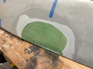 Sanded away gelcoat on one wing, removed a substantial amount of filling.  I will cut a large hole in these regions to allow for cable and manipulation of whatever I choose to couple the lamp attachment bolt to (nutplate, rivnut, possibly on a mounting plate.)