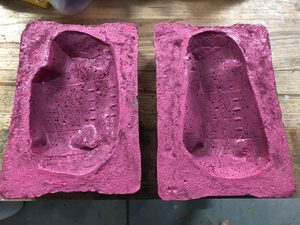 I found that the cement continued to shed a lot of sand, even when more fully cured.  This sand tended to get into the mould.  So I bound the surface with paint.  No, I swear this rattle can paint colour was at hand and that I did not purchase a new can to colour-coordinate!