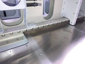 Confirming clearance between the rear edge of the floor skin and the main spar channel