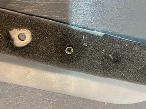 Result of applying the tool accompanied by cleaning with turps with a cotton bud. Note the foam has been pulled away to show the removed adhesive. JB-Weld can then meaningfully be used when setting a rivnut. Here a set rivnut is shown, where the foam has not been pulled away for exposition