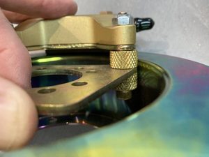 Caliper mounting plate being lifted out - note additional groove in knurled ferrule