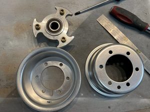 5" hub out disassembly. Note that the milled centre hub holes are also threaded, so it is necessary to ensure these bolts are first torqued into this structure - 120in-lbs - before the nuts are attached.