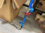 Tie down strap for front fuselage