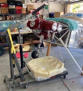 Getting the engine positioned with a hoist. Two people are a must for this process.
