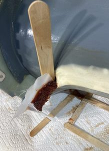 Applying more flox to provide underlying structure when material is sanded away to match the bottom cowling.