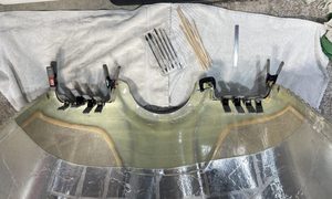 Multiple clamps used to secure the metal seal strips. Flox is used to fill voids and gaps then sanded to contour.