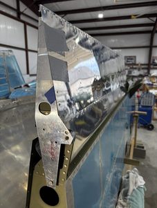 Fixture used to secure the ailerons in the neutral position. The aileron is secured to it with duct tape.