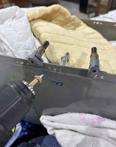 Countersinking the rivers holes. I created a metal backing plate so the countersink tool wouldn't wander in the fiberglass.