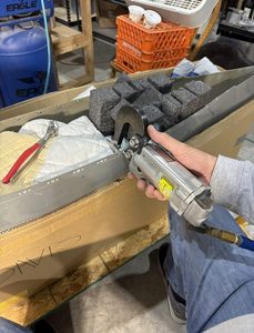 Riveting on all the nutplates with the squeezer. Securing the somewhat flimsy, flexible wing tip for riveting proved challenging. Put wingtip in a large box then stuffed it with rags and foam to make it more rigid.
